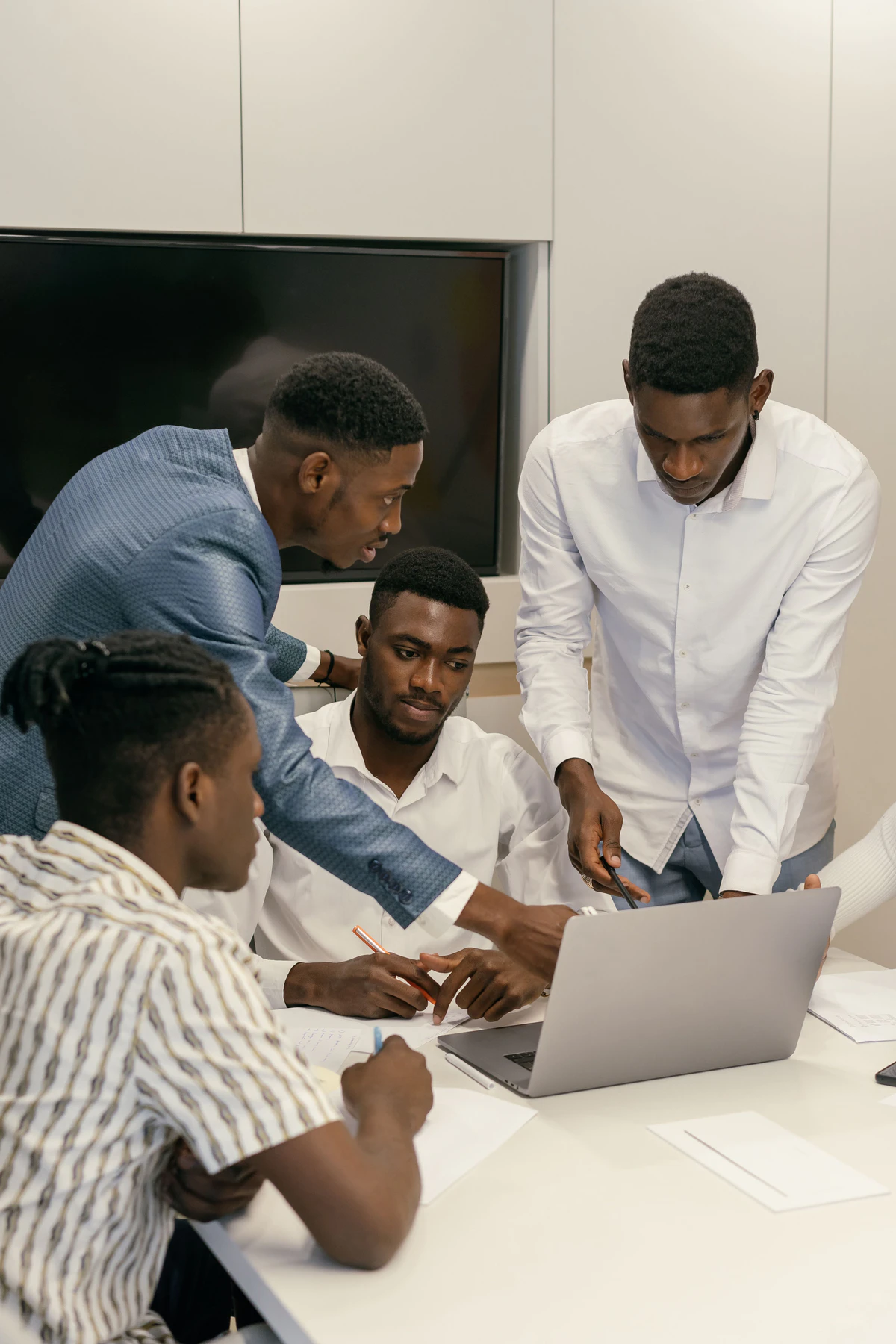 NexHRM team collaborating around a laptop
