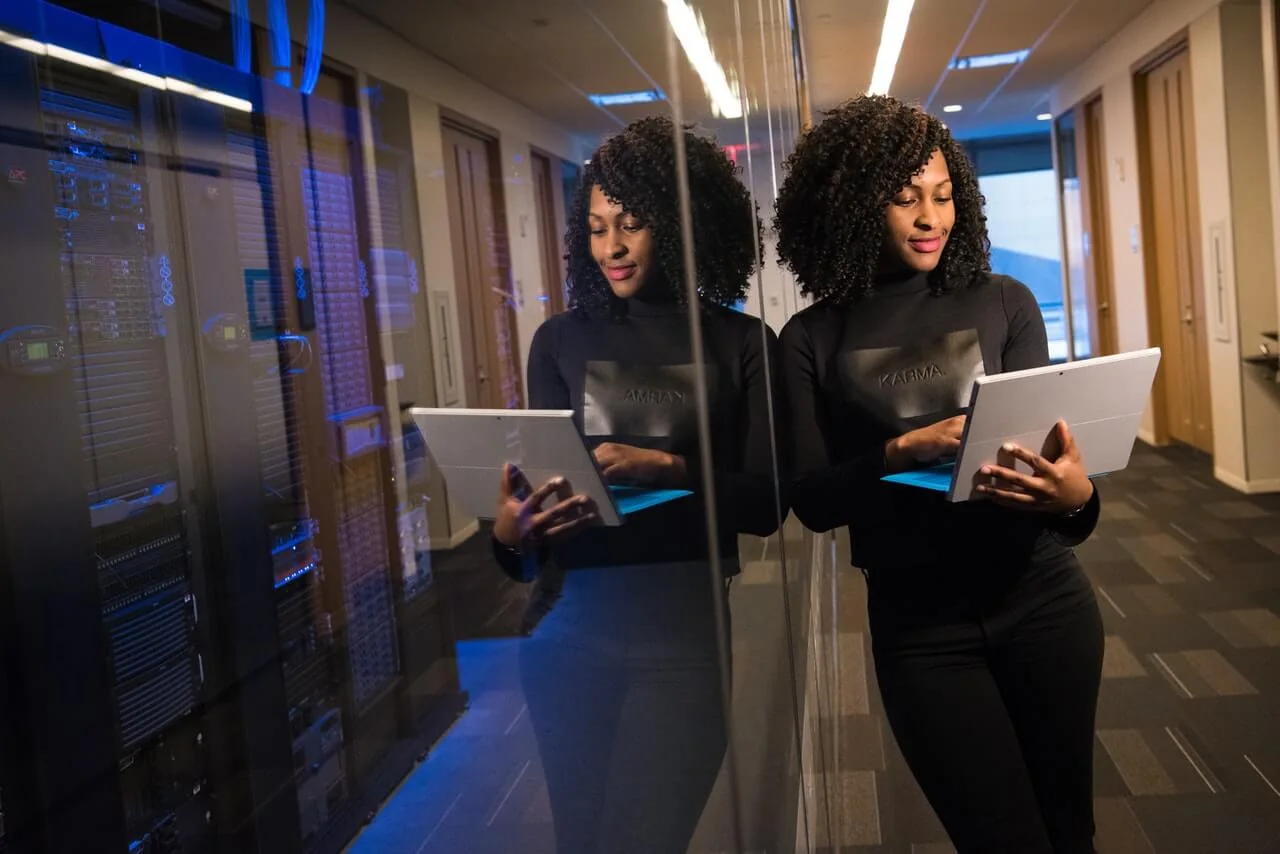 NexHRM team member using a tablet alongside business systems.